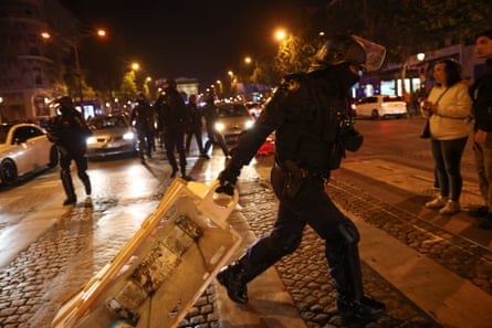 A police officer clears the way at the Champs Élysées