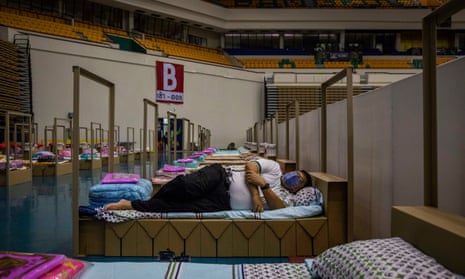 A Bangkok metropolitan administration employee tests out a cardboard bed at a field hospital for Covid-19 patients in Bangkok.