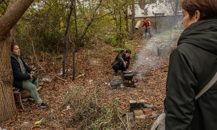 Women cook using wood fire in the suburbs of Kherson.