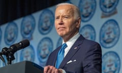 President Joe Biden speaks at a dinner for the Detroit chapter of the National Association for the Advancement of Colored People. He stands at a podium gazing out at the audience