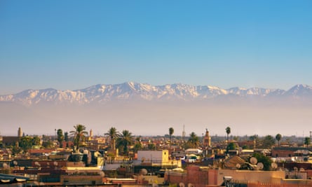 The Atlas mountains shimmer over Marrakech.