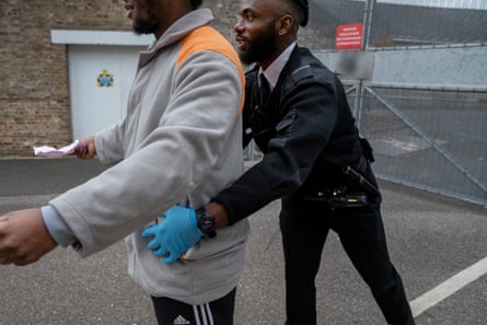Chibs Ekeiwu searches a prisoner