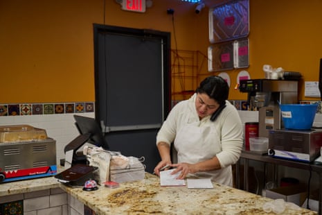 A woman on the phone taking bakery orders