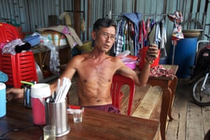 Heng Ngy lives in a wooden house over a sea of plastic.