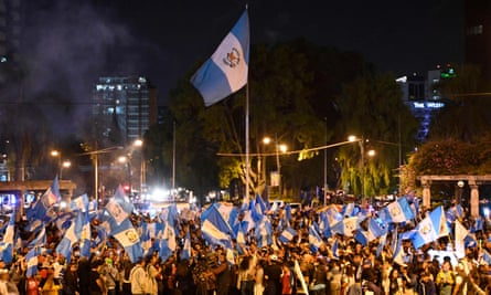 People wave flags in Guatemala City