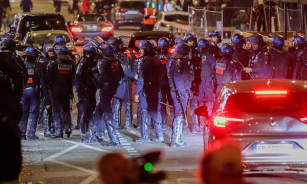 Riot police forces secure the area near the Arc de Triomphe during another night of clashes with protesters in Paris