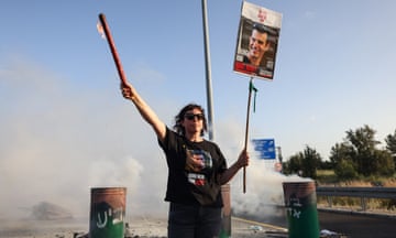 A woman bearing the image of Israeli hostage Dror Or, who has been confirmed dead by Israel’s government.