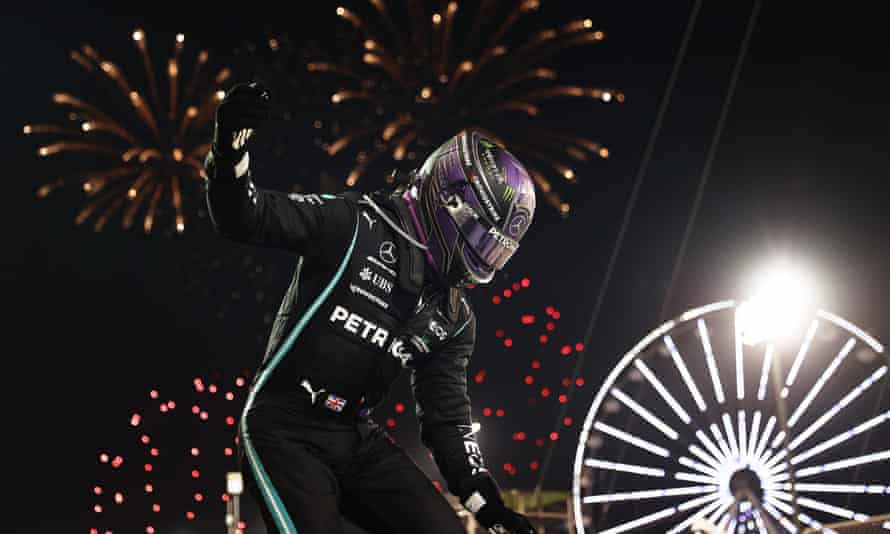Lewis Hamilton celebrates his remarkable win at the Bahrain Grand Prix as fireworks erupt in the background at the Sakhir circuit.