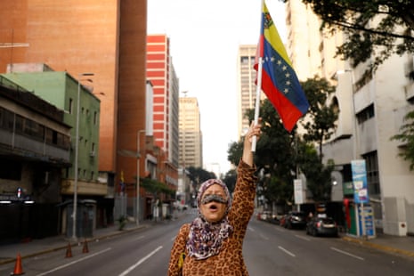 A supporter of Venezuelan president Nicolás Maduro holds a flag of Venezuela on a street near Miraflores palace in Caracas, Venezuela, on Saturday.
