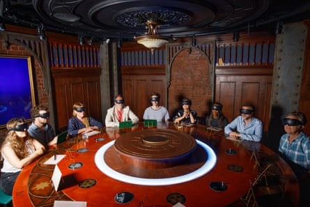 Participants sat round a round table wearing blacked-out ski goggles
