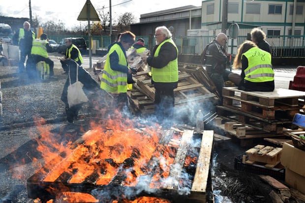 Gilets Jaunes (Yellow vest) protestors man a barricade in Montabon, northwestern France, at an access to an oil depot they block since December 2 as part of the Gilets Jaunes protests.