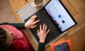 woman using a laptop on a dining room table set up as a remote office to work from home.