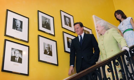 The then prime minister David Cameron walks Queen Elizabeth down the staircase at 10 Downing Street with his wife, Samantha, in June 2011.