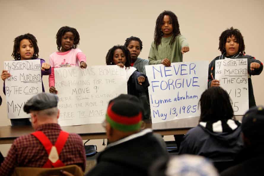 MOVE members’ children chant slogans at the start of a news conference in Philadelphia, Wednesday, May 12, 2010. Ramona Africa, a survivor of the 1985 fatal police bombing in Philadelphia, wants to file private criminal complaints charging former city officials with murder.