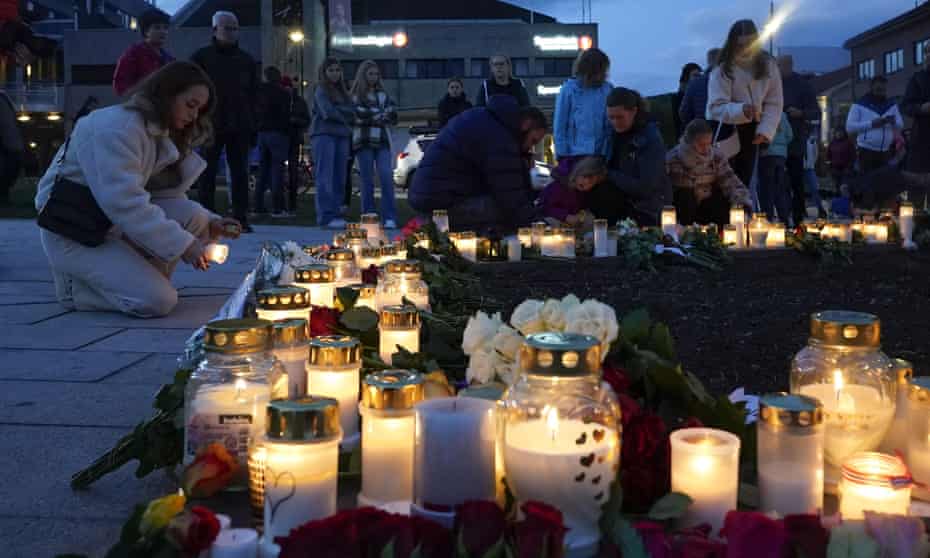 People place flowers and candles in Kongsberg, Norway, on Thursday evening after the bow and arrow attack that left five dead. 