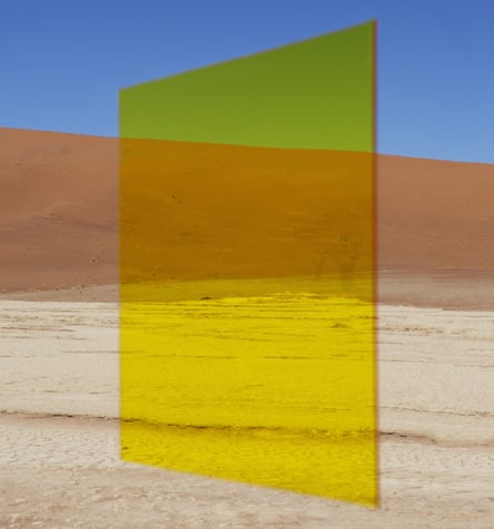 An abstract work of a translucent yellow monolith in a desert landscape
