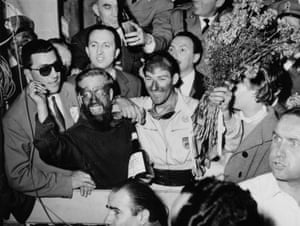 Stirling Moss, and his partner Denis Jenkinson, celebrate after winning the 1955 Mille Miglia