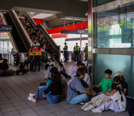 People take shelter inside a metro station, during an air raid drill in Taipei.