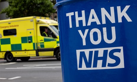 An ambulance passes a postbox painted with ‘Thank you NHS’ outside St Thomas' hospital in London