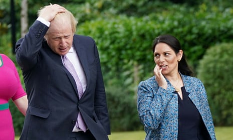 Boris Johnson and Priti Patel during a visit to Surrey police headquarters in Guildford, Surrey