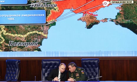 Putin with close confidant General Valery Gerasimov in front of a screen showing a map of Ukraine, Moscow, December 2021.