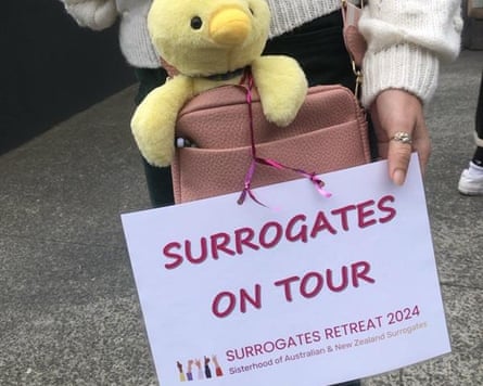 A laminated ‘Surrogates on Tour’ sign