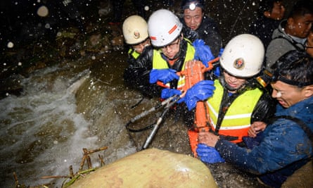 Rescuers drawing water at a flooded area in China’s northern Shanxi province