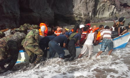 Rescuers assist villagers in a boat during evacuation efforts in Petite Savanne, Dominica.