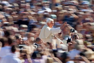 Benedict waves as he arrives to lead his weekly audience in St Peter’s Square in 2009