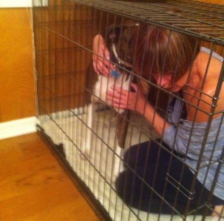 Brenda Leyland in a dog cage with Sweep, the boxer