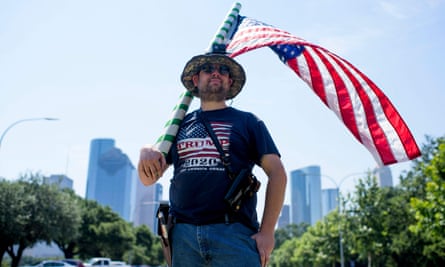 Kenny Wolfam open carries a pistol and wears a ‘Trump 2020’ T-shirt while counter-protesting a ‘Moms Demand Action’ protest in response to a new Texas gun law at Buffalo Bayou Park in Houston, Texas, last month.