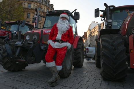 A farmer, wearing Santa costume, is seen as farmers from different regions of the United Kingdom gather with their tractors to protest on budget day, demanding fair reforms in agricultural policies and the reversal of changes to inheritance tax in London on November 26, 2025.