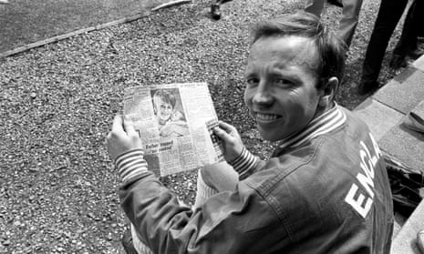 Nobby Stiles looking at a newspaper story about his wife giving birth during an England training session at Lilleshall