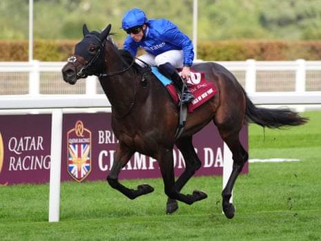 William Buick leans forward riding Talk of New York, a galloping brown racehorse, at Ascot