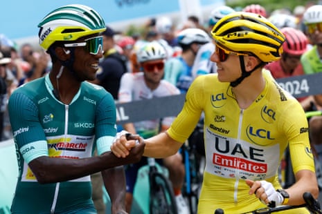 Race leader Tadej Pogacar greets points leader Biniam Girmay at the start of stage 12.