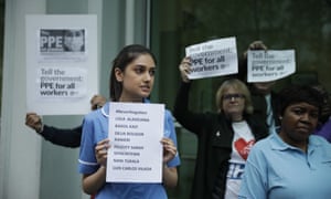 Hospital workers hold up signs calling for personal protective equipment