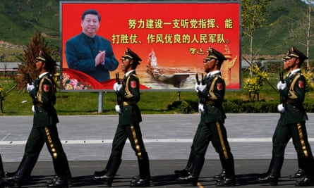 Soldiers of the people’s liberation army march past an image of the Chinese president, Xi Jinping, during rehearsals for the military parade on 3 September. 