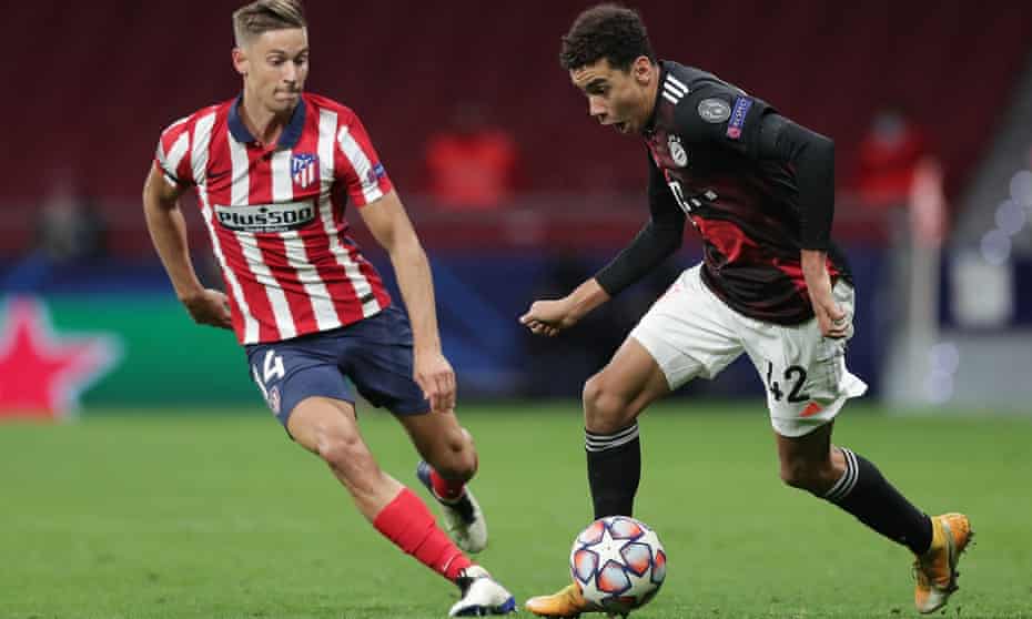 Bayern Munich’s Jamal Musiala takes on Marcos Llorente