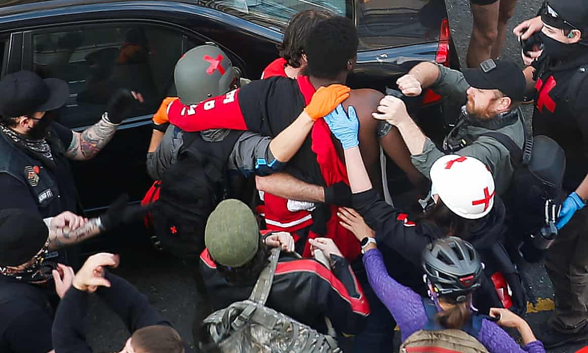 Black Lives Matter protesters in Seattle help a gunshot victim who confronted a man who tried to drive through the crowd then opened fire