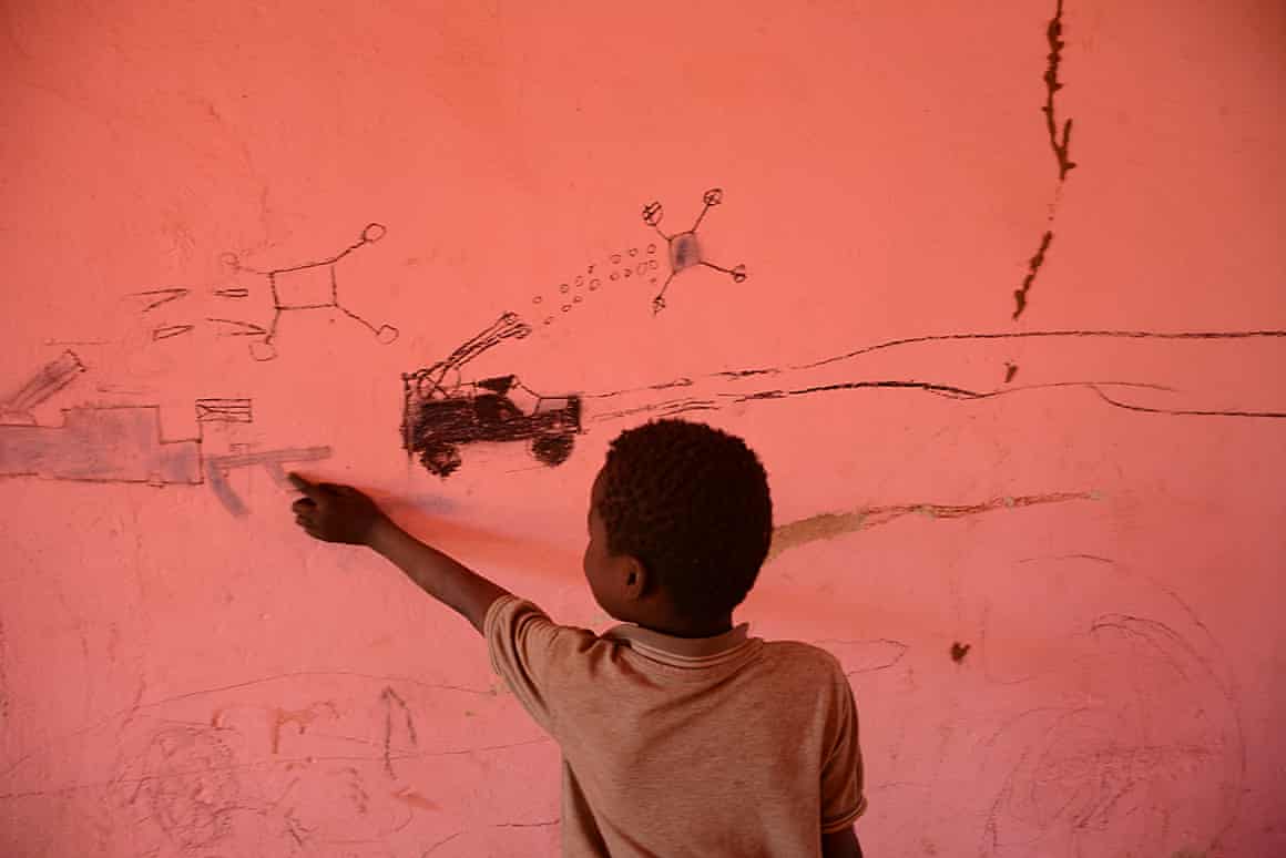 Mujtaba gestures at his drawings