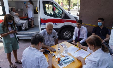 Iranians preparing to get vaccinated at a mobile centre in Yerevan, Armenia today.