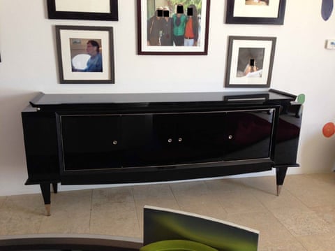 framed photos above a console