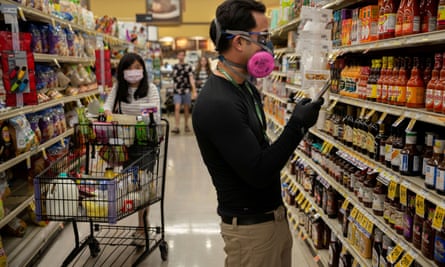 People wear masks while grocery shopping in Tucson, Arizona, 4 April 2020.