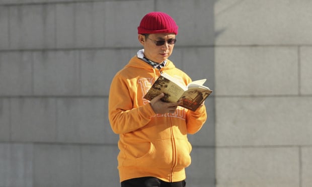 Xiao Jianhua reads a book outside the International Finance Centre in Hong Kong in December 2013, just months before he was allegedly abducted.
