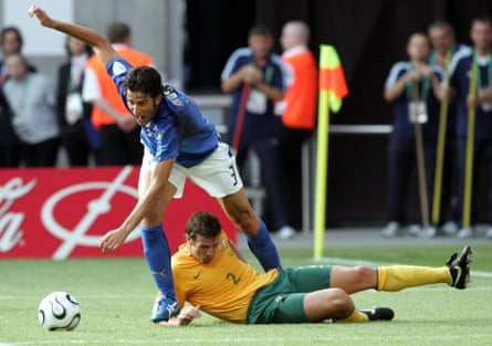 Lucas Neill lies beneath Fabio Grosso after a tackle