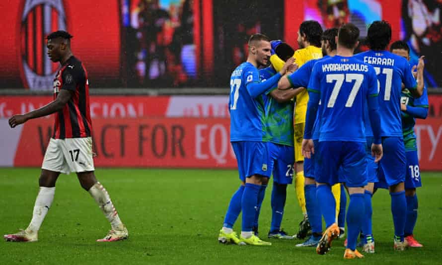 The Sassuolo players celebrate winning at San Siro as AC Milan’s Portuguese forward Rafael Leão (left) walks off.