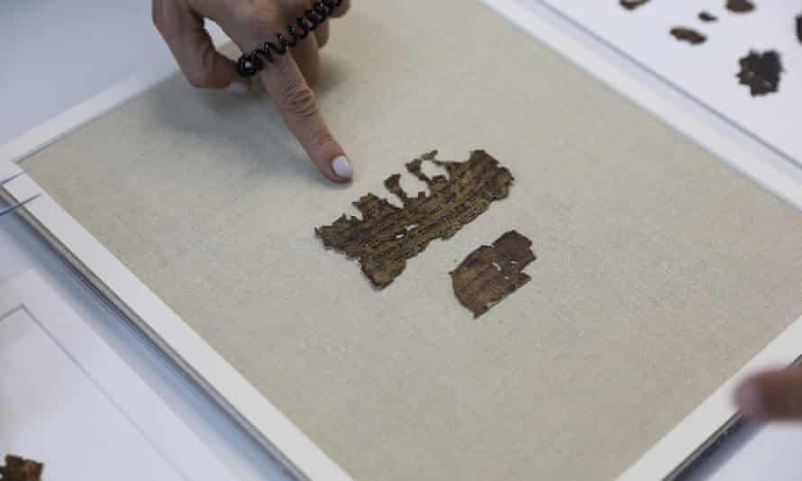 Beatriz Riestra, a researcher of the Israel Antiquities Authority, shows newly discovered Dead Sea scroll fragments.