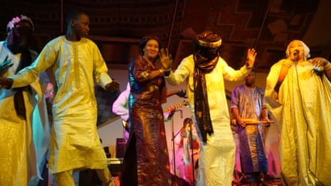 Audience members join Khaira Arby, the diva of Timbuktu, on stage 
