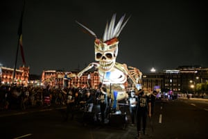 People carry an effigy during a Day of The Dead festival in Zócalo, the main square, in Mexico City