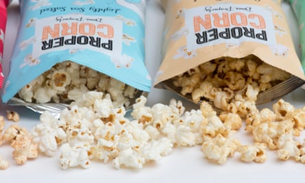 Two open bags of Propercorn-branded popcorn